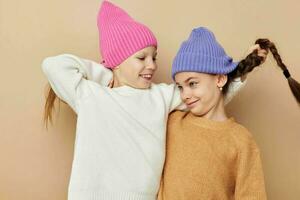 two funny little girls in colorful hats photo