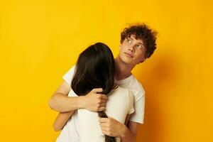 portrait of a man and a woman hug friendship relationship fun yellow background unaltered photo