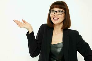 portrait of a woman posing with glasses a leather suit black jacket isolated background photo