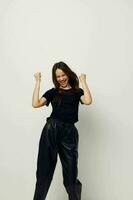 athletic woman in black pants and a T-shirt fashion isolated background photo