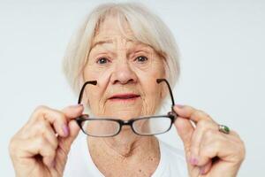 Photo of retired old lady vision problems with glasses close-up