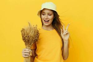 Young woman bouquet of dried flowers casual wear smile posing yellow background photo