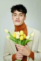 handsome guy bouquet of flowers romance fashion date isolated background unaltered photo