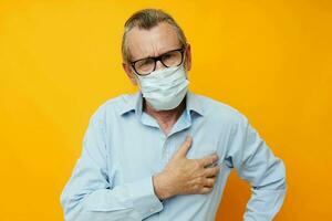 Photo of retired old man in medical mask protection isolated background