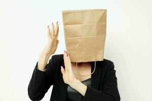 portrait of a woman with a bag on his head in a black jacket red nail polish isolated background photo