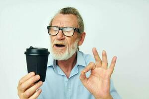 old man gestures with his hands a glass of drink isolated background photo