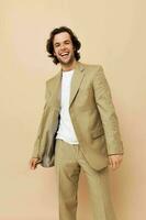 Cheerful man in beige suit elegant style isolated background photo