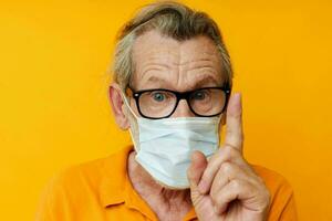 elderly man medical mask on the face protection close-up isolated background photo