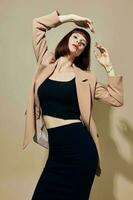 beautiful woman in a beige jacket elegant style posing light background photo