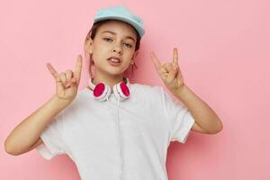 Portrait of happy smiling child girl wearing headphones posing emotions isolated background photo