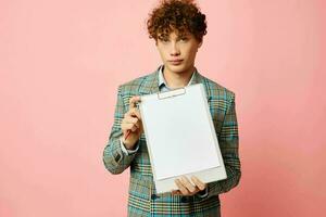 cute red-haired guy in a business suit copy-space documents pink background unaltered photo