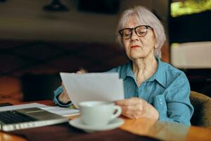 A businesswoman working in front of laptop monitor sitting Retired woman chatting unaltered photo