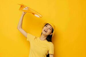 Portrait Asian beautiful young woman with a yellow plane in his hands a toy Monochrome shot photo