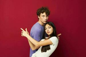 guy and girl posing studio red background photo