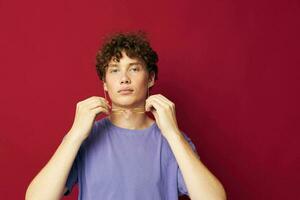 portrait of a young curly man posing emotions close-up isolated background photo