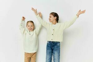 two little girls girlfriends posing light background photo