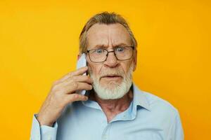 Portrait of happy senior man talking on the phone posing close-up isolated background photo