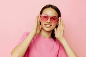 photo pretty woman in stylish glasses posing emotions pink background