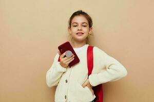 cute girl with phone posing red backpack Lifestyle unaltered photo