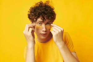 cute red-haired guy wearing stylish glasses yellow t-shirt posing monochrome shot photo