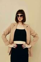 photo pretty woman in a beige jacket elegant style sunglasses isolated background