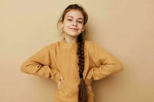 little girl long pigtail beige sweater grimace childhood unaltered photo