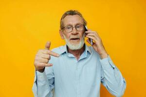 old man gray beard with glasses talking on the phone isolated background photo