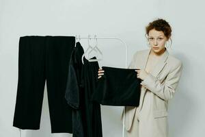 portrait of a young woman In a light classic suit clothes hanger isolated backgrounds unaltered photo