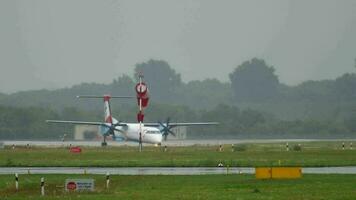 DUSSELDORF, GERMANY JULY 24, 2017 - Austrian Airlines Bombardier Dash 8 taxiing after landing at rain early morning. Dusseldorf airport, Germany video