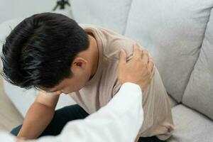 psychiatrist holds shoulders while discussing life and family issues. doctor encourages and empathy woman suffers depression. psychological, save divorce, Hand in hand together, trust, care photo