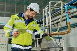 Engineers or factory managers wearing safety helmet inspect the machines in the production line. Utility inspector check machine and test the system to meet the standard. machine, maintenance. photo