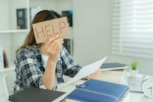 Asian student woman have anxiety because of exams, female prepare for test and learning lessons in the library. stress, despair, haste, misunderstanding reading, discouraged, expectation, knowledge photo