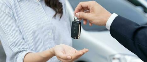 lease, rental car, sell, buy. Dealership manager send car keys to the new owner.  Sales, loan credit financial, rent vehicle, insurance,  renting, Seller, dealer, installment, car care business photo