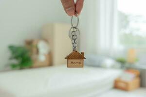 Moving house, relocation. Man hold key house keychain in new apartment. move in new home. Buy or rent real estate. flat tenancy, leasehold property, new landlord, investment, dwelling, loan, mortgage. photo