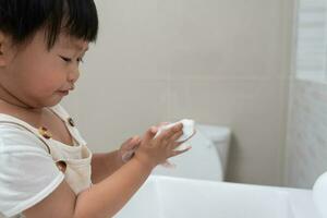 little kid hands wash with soap bubbles and rinse with clean water to prevent and stop the spread of germs after back to home, virus or covid19. Good health and good personal hygiene, virus, bacteria photo