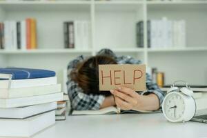 Asian student woman have anxiety because of exams, female prepare for test and learning lessons in the library. stress, despair, haste, misunderstanding reading, discouraged, expectation, knowledge photo