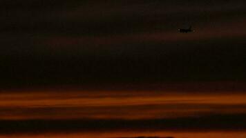 The aircraft on the final approach before landing on the background of the sunset dusk sky video