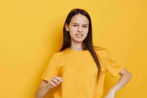 young woman in a yellow t-shirt emotions summer style isolated background photo