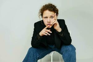 beautiful woman sitting on a chair in a black jacket fashion posing Lifestyle unaltered photo