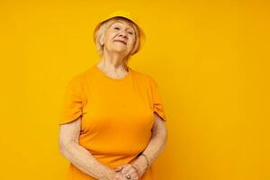 Photo of retired old lady in casual t-shirt yellow panama close-up emotions