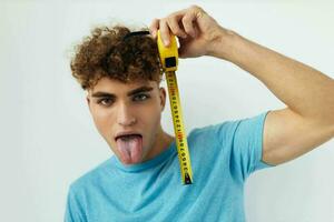 handsome young man emotions grimace measuring tape Lifestyle unaltered photo