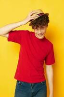 guy with red curly hair emotions red t-shirt hat studio yellow background unaltered photo