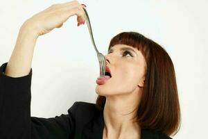 portrait of a woman short-haired in a black jacket cutlery isolated background photo