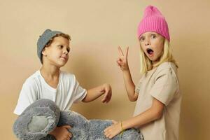 Boy and girl in multi-colored hats entertainment posing isolated background photo