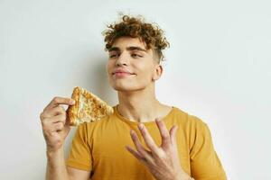 kinky guy in a yellow t-shirt eating pizza Lifestyle unaltered photo