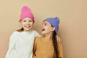 two funny little girls in colorful hats photo