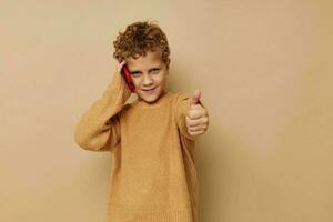 little boy with curly hair red phone technology fun photo