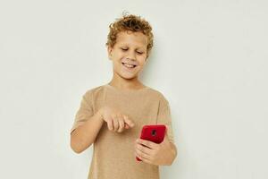 Cheerful cute boy with phone in hands posing technology photo