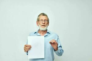 elderly man holding a sheet of paper copy-space posing isolated background photo