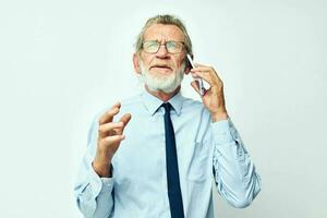 old man with phone in studio on white background talking photo